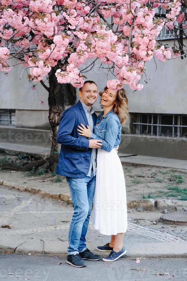 couple in love in a blooming Apple orchard lying on the blanket photo