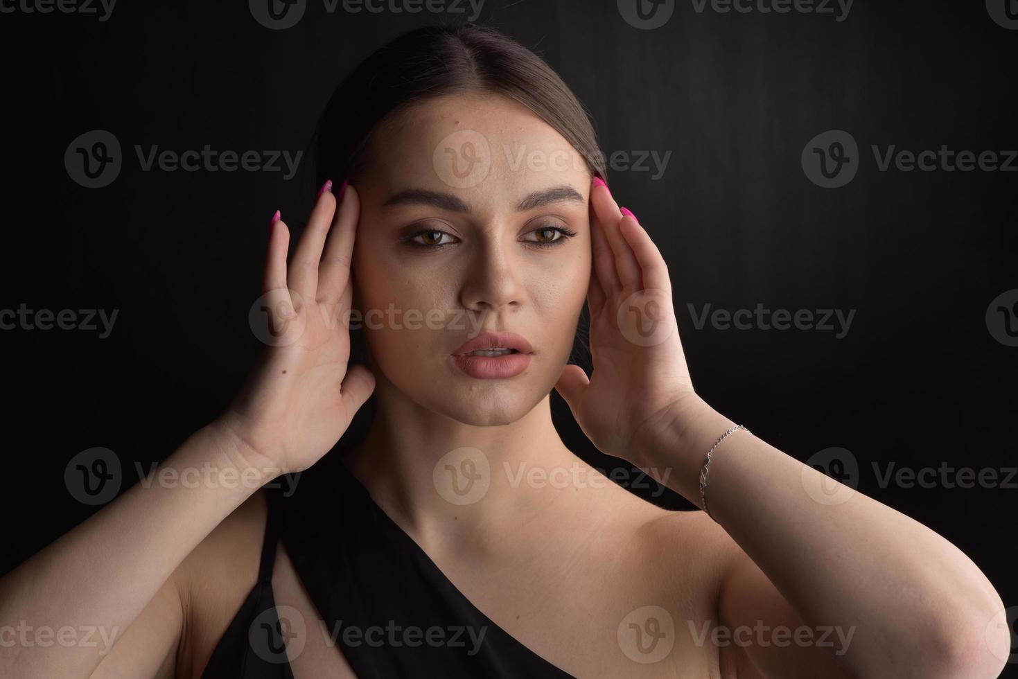 Beautiful Woman in Black Dress on black Backgound photo