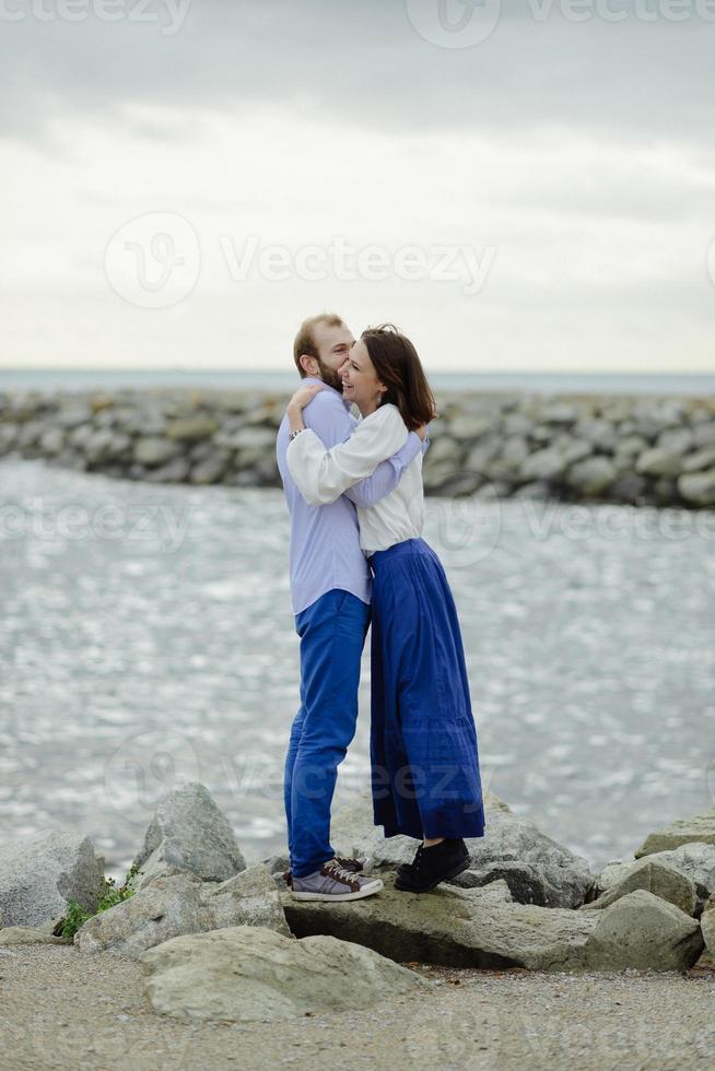 A loving couple, man and woman enjoying summer vacation on a tropical paradise beach with clear sea ocean water and scenic photo