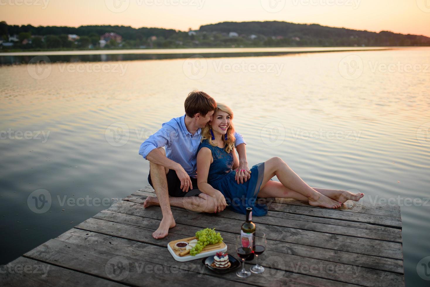 Man and woman on the pier near the lake. photo