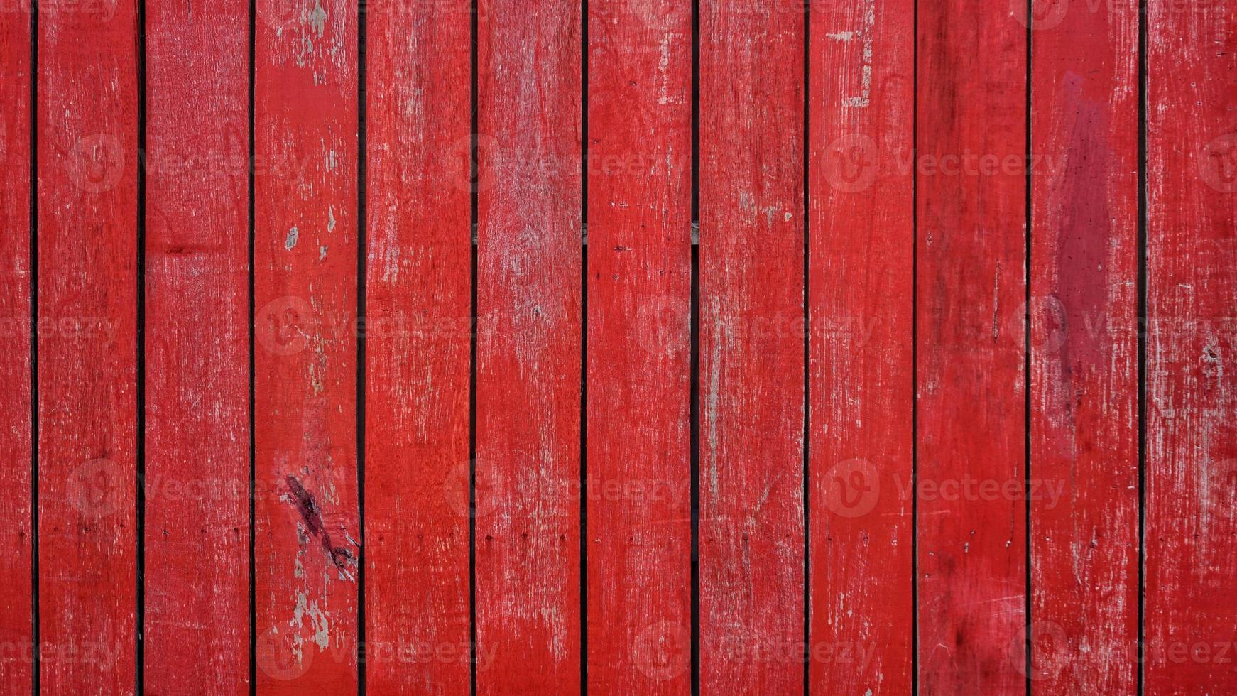Wood planks wall painted red color with texture of cracks and scratch texture background. photo
