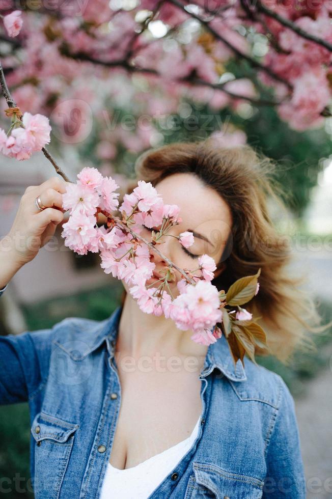 hermosa mujer disfrutando del campo de margaritas, linda mujer acostada en un prado de flores, linda chica relajándose al aire libre, divirtiéndose, sosteniendo la planta, jovencita feliz y naturaleza verde primaveral, concepto de armonía foto