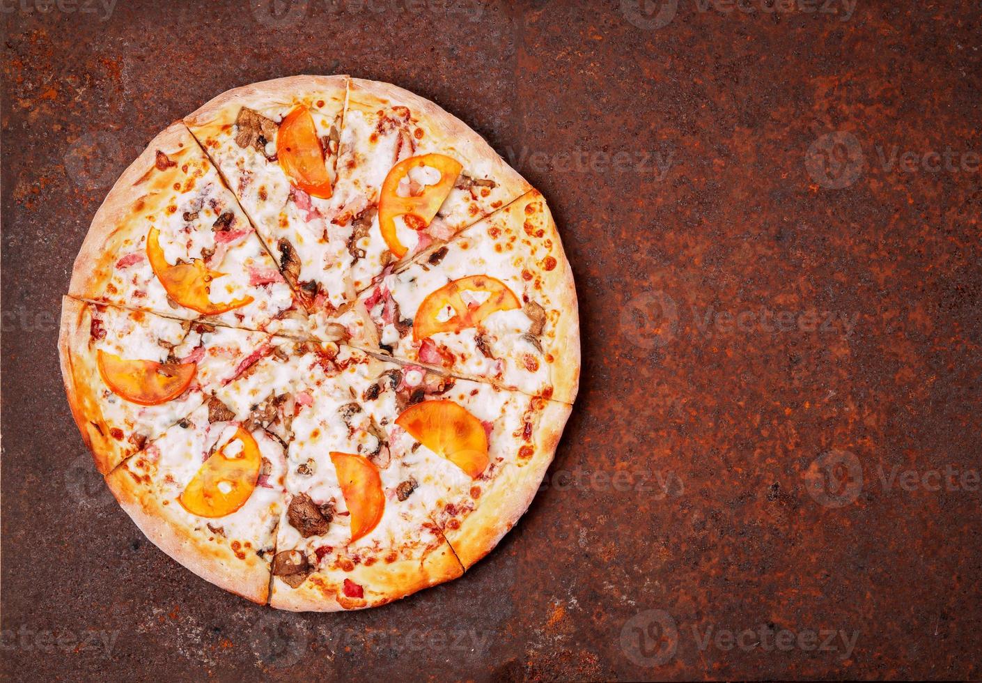 round Italian pizza bbq on a rusty metal desk top view, empty space for text. photo