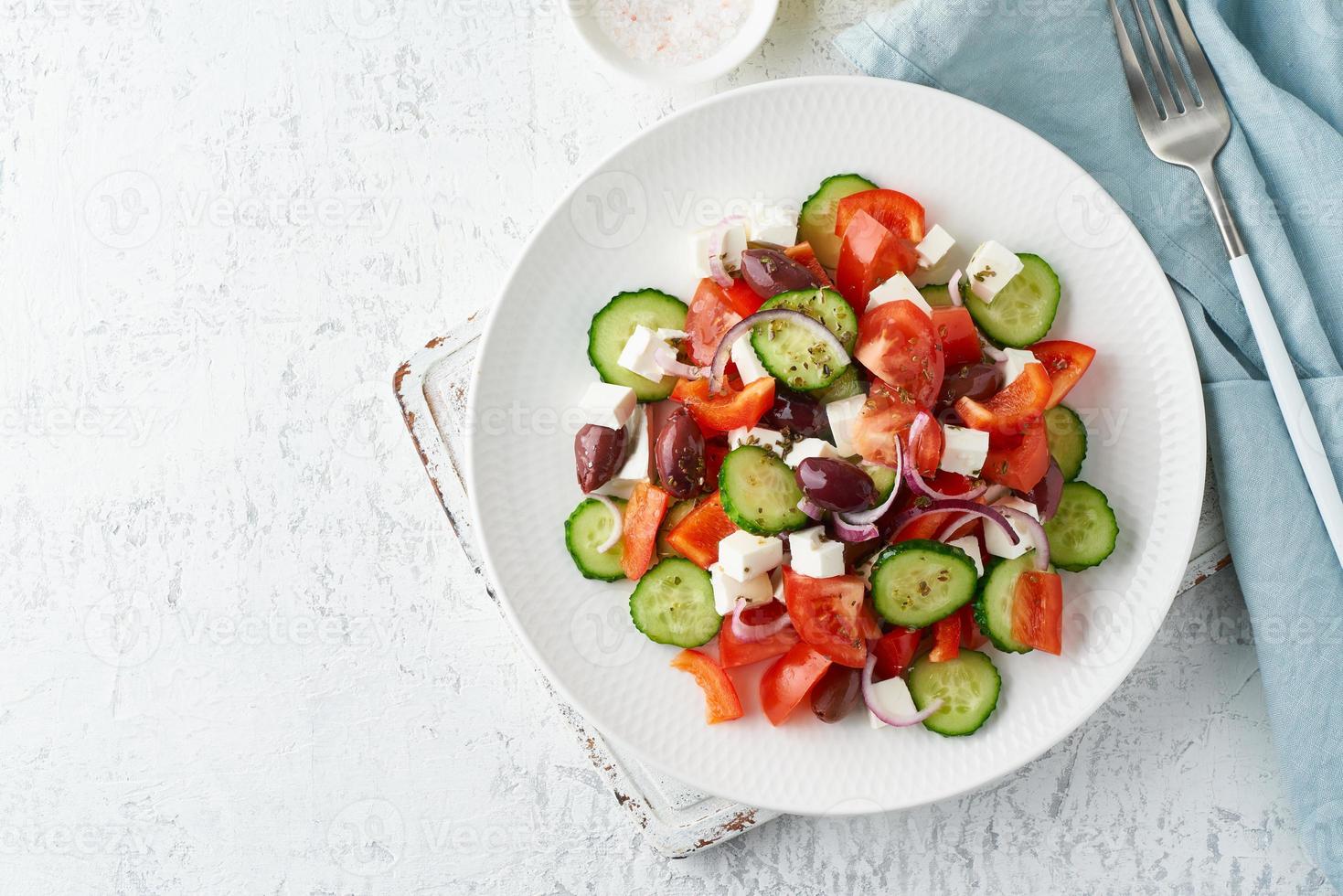 Greek village salad horiatiki with feta cheese, olives, cherry tomato, cucumber and red onion photo