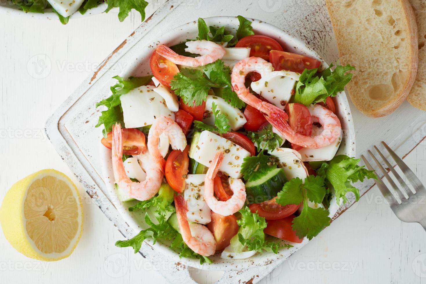 Seafood salad with squid, shrimp, cucumbers, tomatoes and lettuce. LCHF