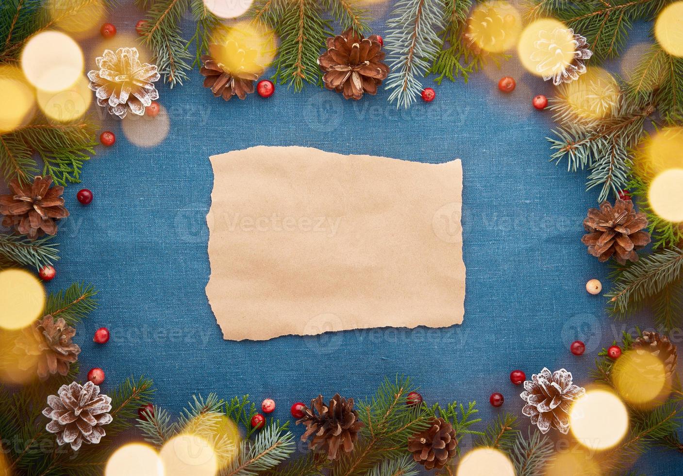 Christmas and Happy New Year dark blue background with craft paper for text and bokeh photo