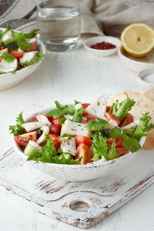 Seafood salad with squid, shrimp, cucumbers, tomatoes and lettuce. LCHF, FODMAP photo