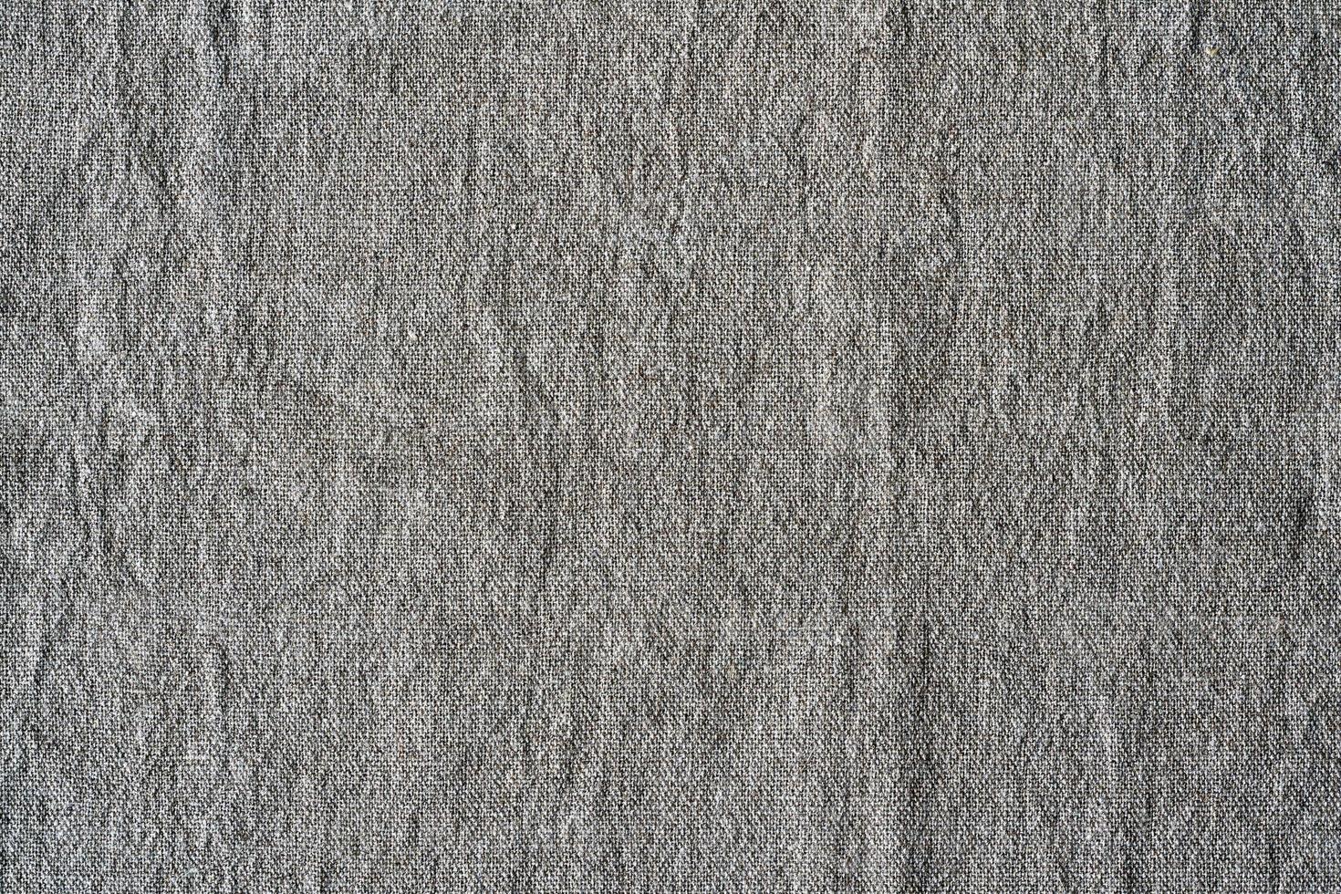 Natural linen texture background. Crumpled fabric of gray color, rough texture photo