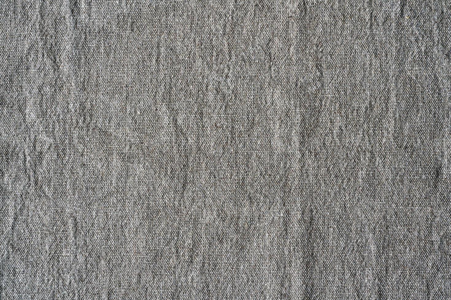 Natural linen texture background. Crumpled fabric of gray color, rough texture photo