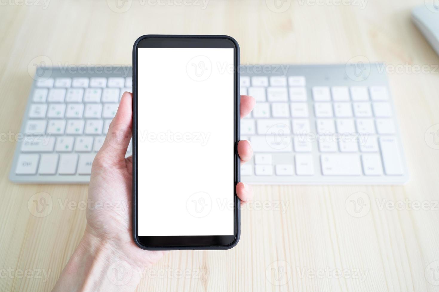 Unrecognizable person hold cell phone. View from behind, mockup with white phone display photo