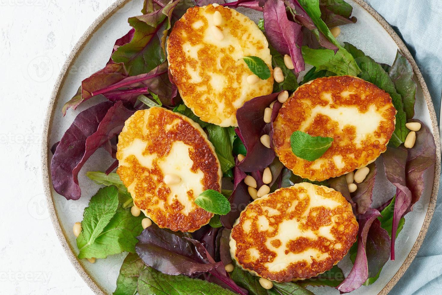 Cyprus fried halloumi with salad mix, beet tops. Lchf, pegan, fodmap, paleo photo