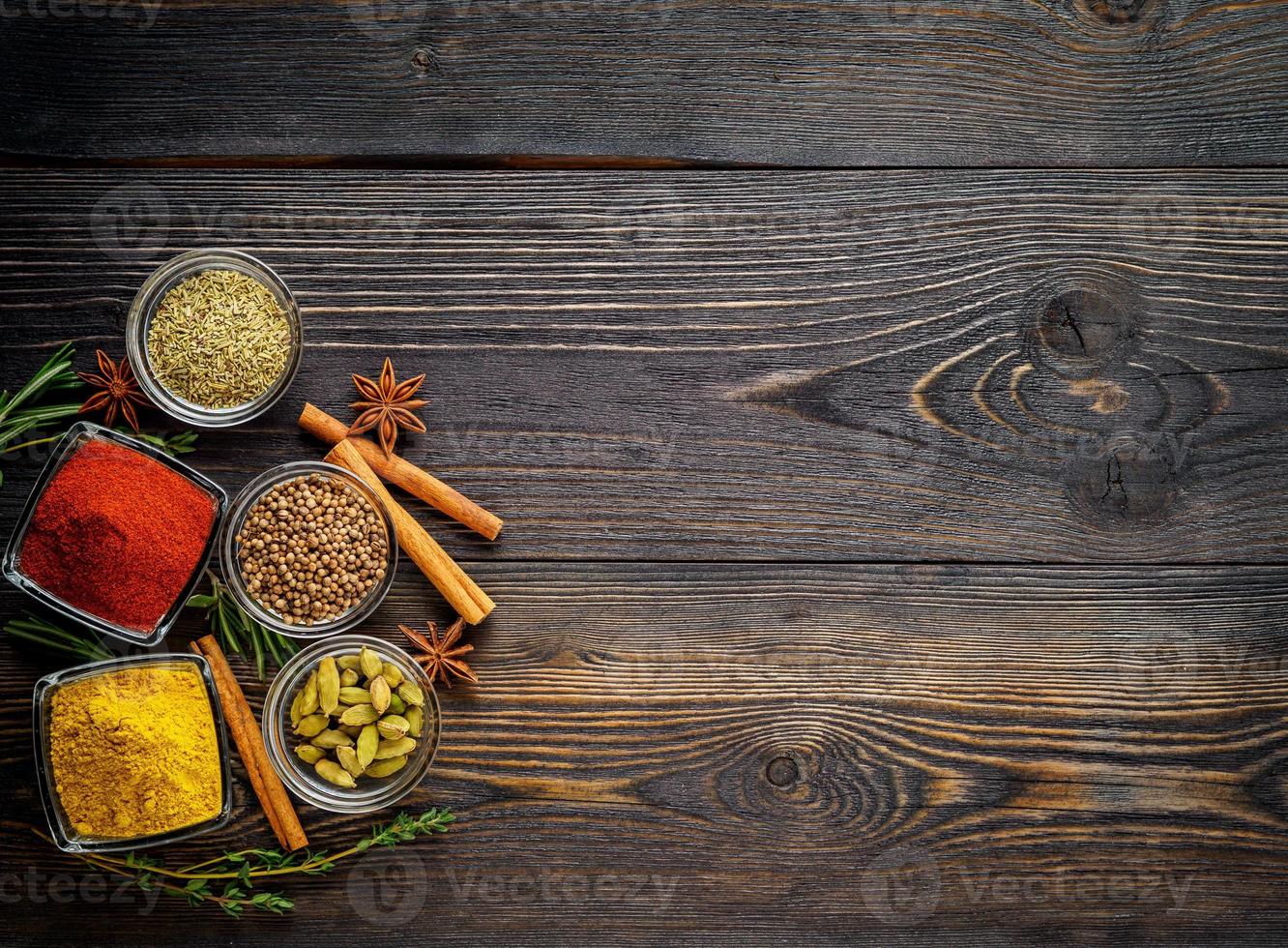 Set of spices and herbs on dark brown textured wooden table. Top view,  empty space 7189382 Stock Photo at Vecteezy