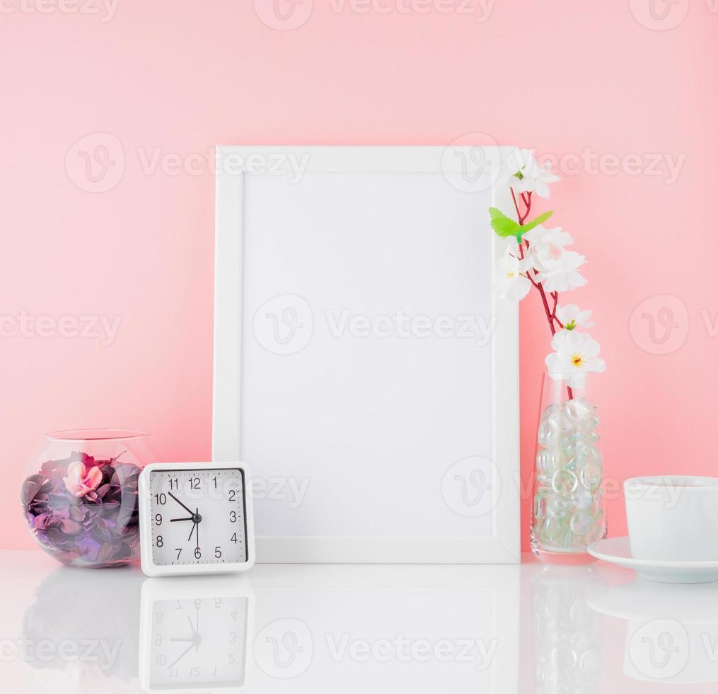 marco blanco en blanco, flor, reloj y taza de café o té en whi foto