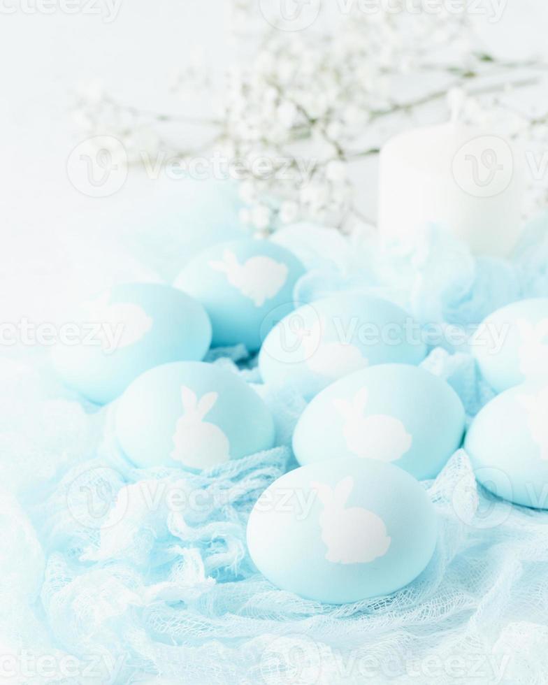 Easter. Holiday. Light white background, gentle pastel colors. Flowers in background, side view photo