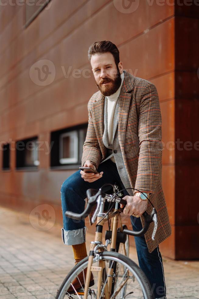 Young man using smartphone with mobile app. Creative businessman in a modern business area. photo