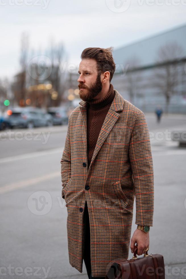 Business portrait of standing man in outdoor. Looking away. Vertical image. photo