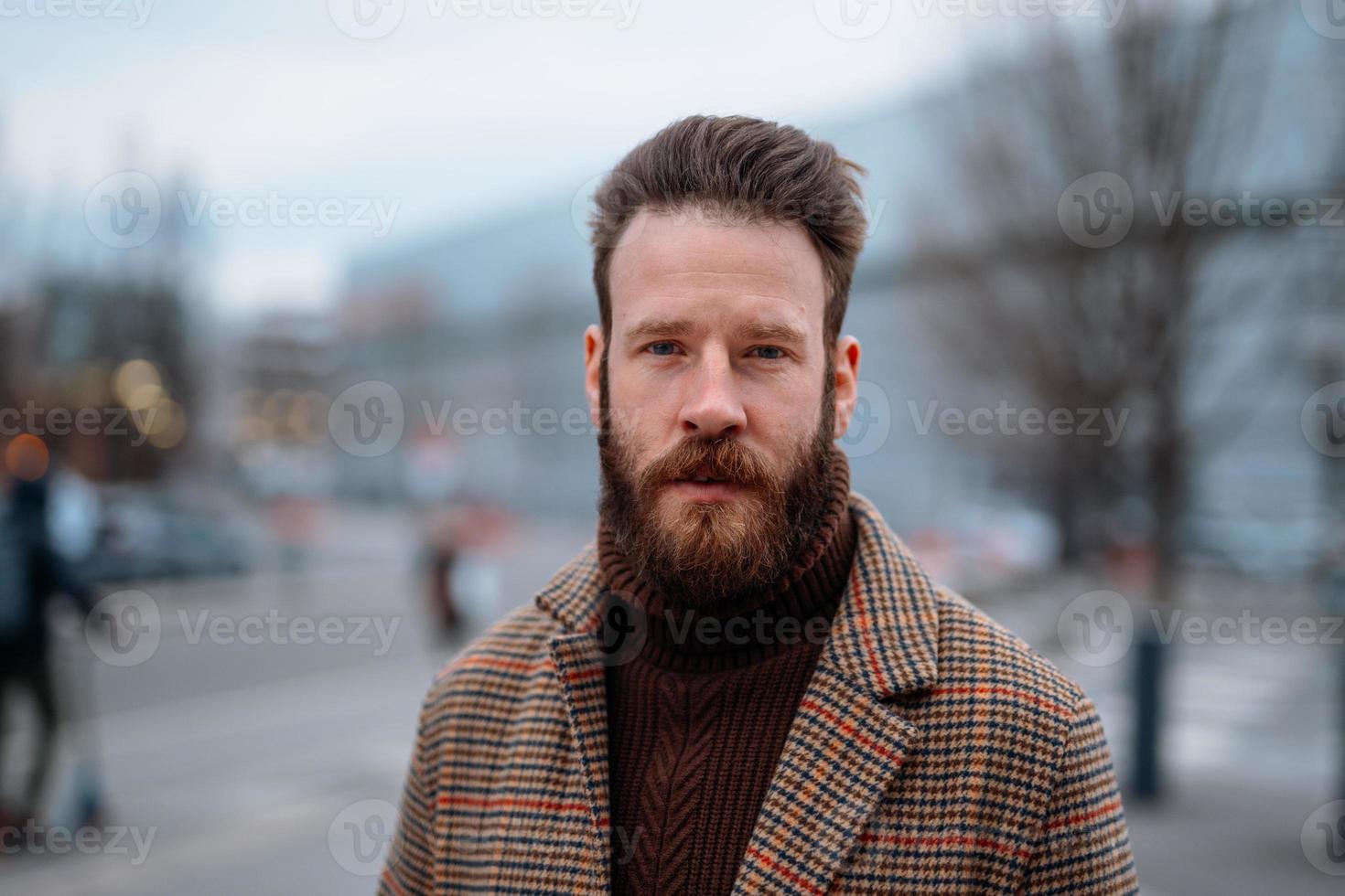 Business portrait of standing man in outdoor. Looking to camera photo