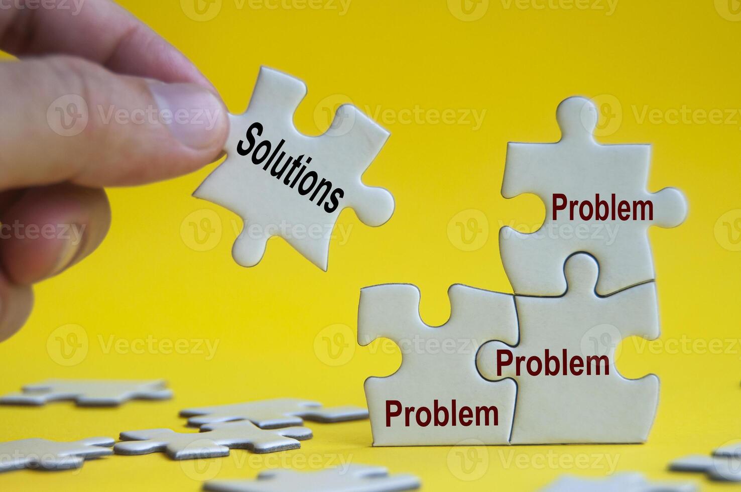 Problem and solutions text on jigsaw with one hand holding a missing jigsaw pieces. photo