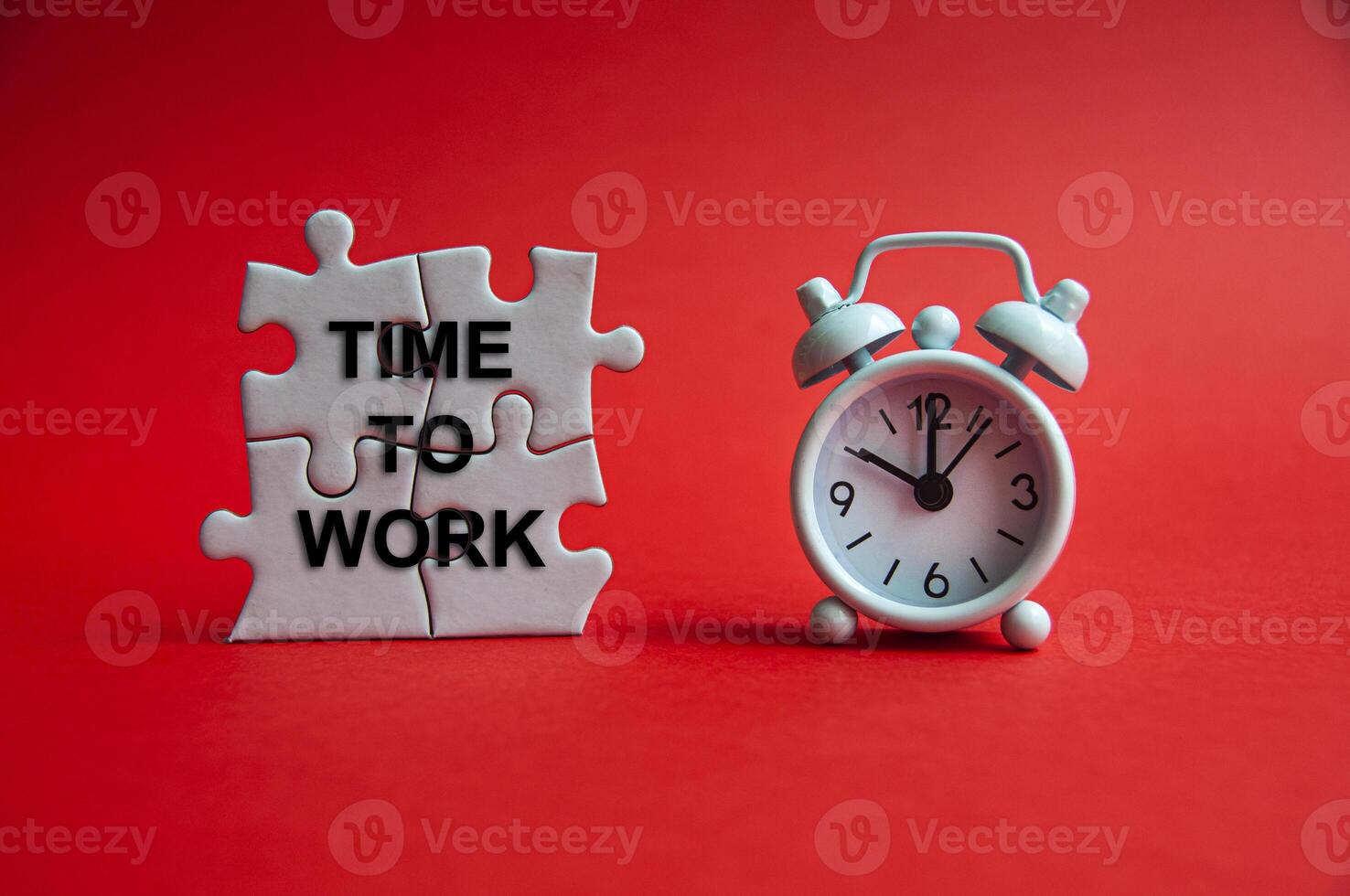 Time to work text on jigsaw puzzle with alarm clock pointing at 10 o'clock. Working and Business concept photo