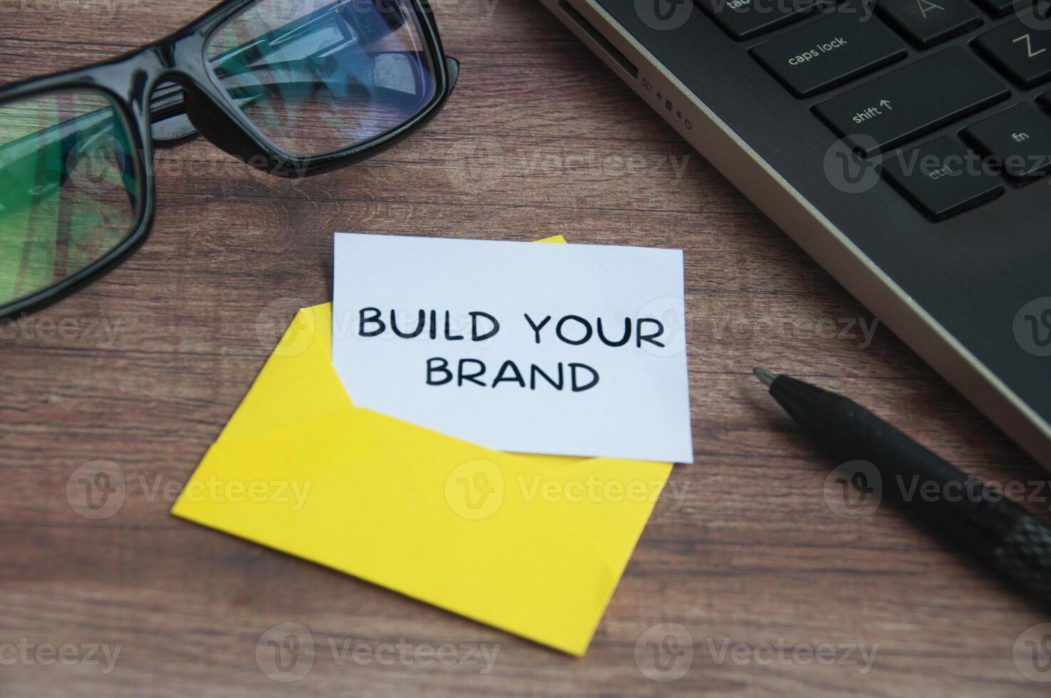 Build your brand text on small piece of paper in an envelope with office concept background. photo