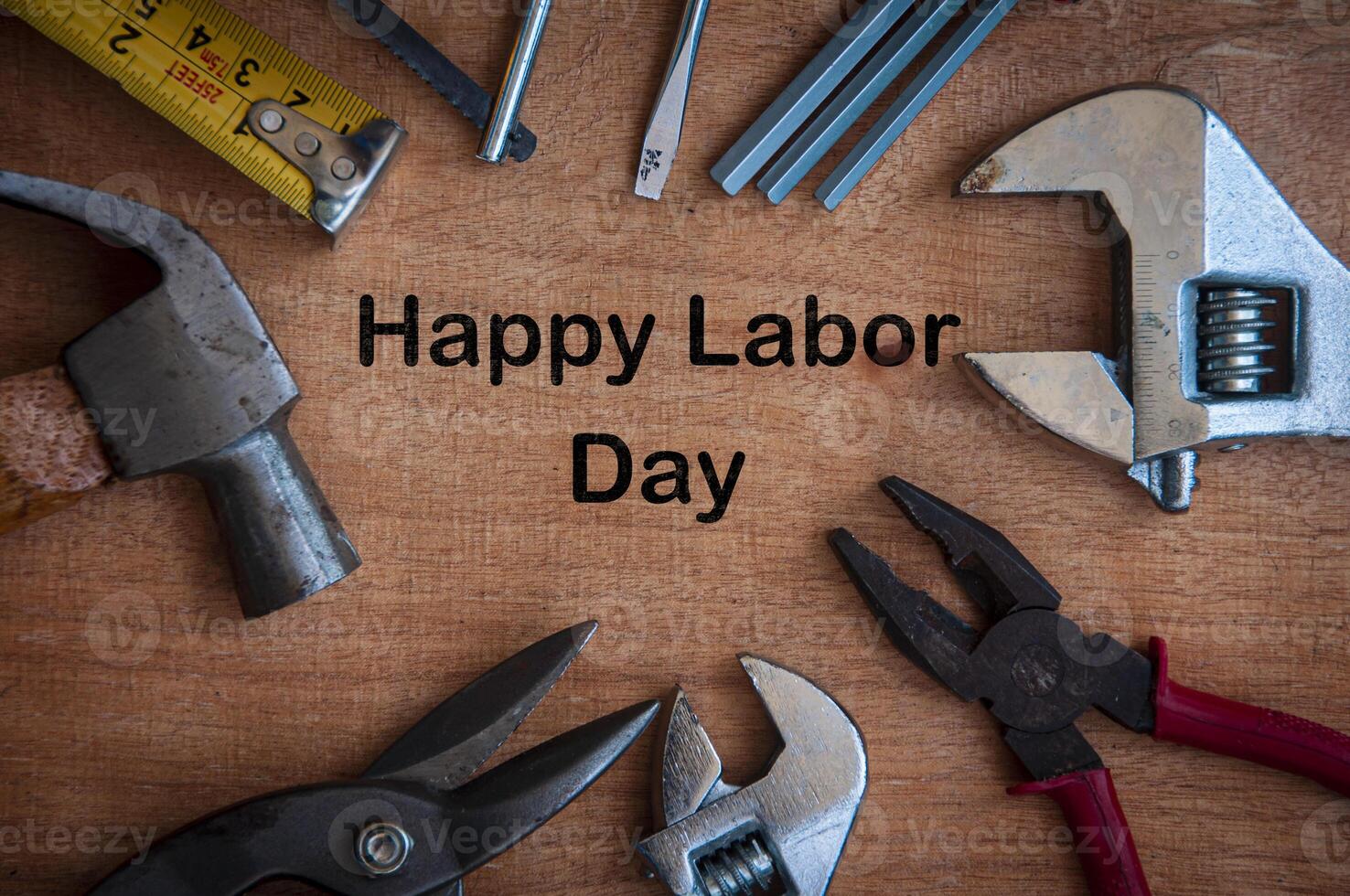 Text on wooden desk - Happy Labor Day with working tools background. photo