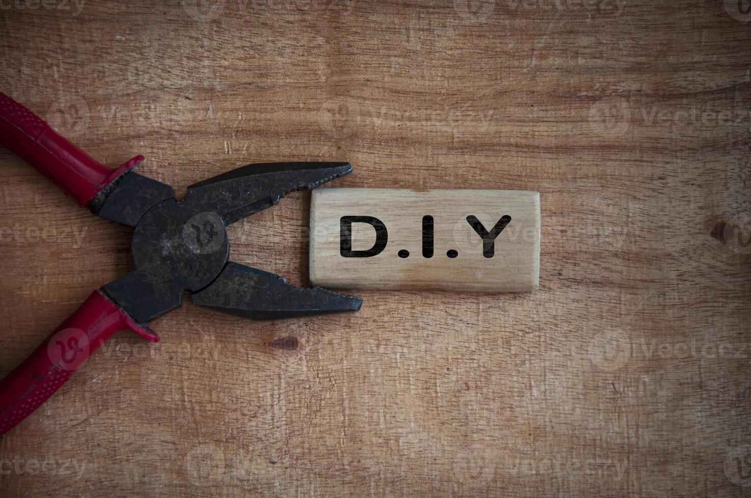 Text on wooden block - D.I.Y with working tool background. photo