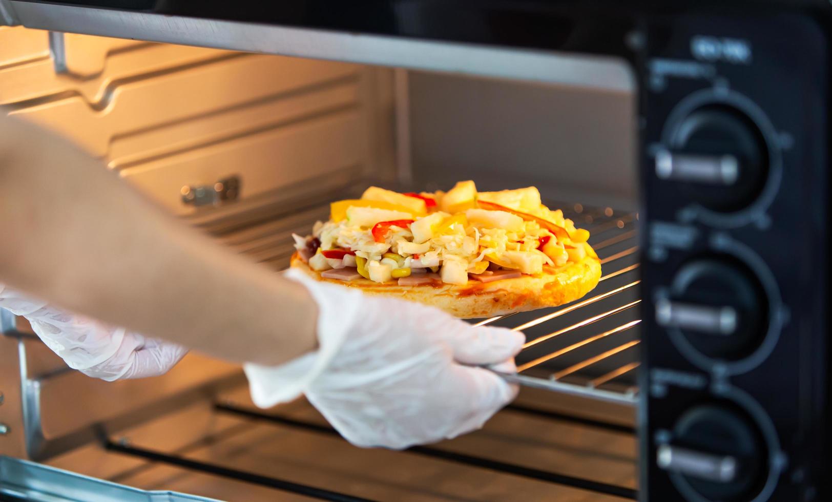 Cooking homemade pizza using oven at home photo