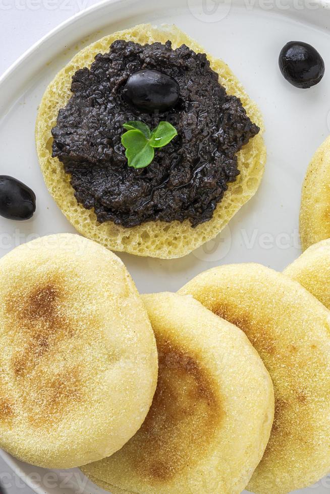 Homemade harcha semolina bread pancakes with olives mashed photo