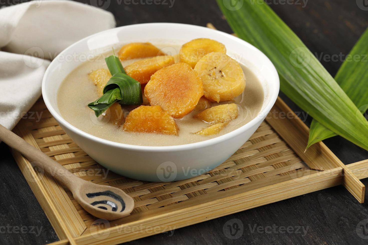 kolak pisang ubi, postre popular indonesio para takjil ramdan rompiendo el ayuno, sopa dulce hecha de plátano y batata foto