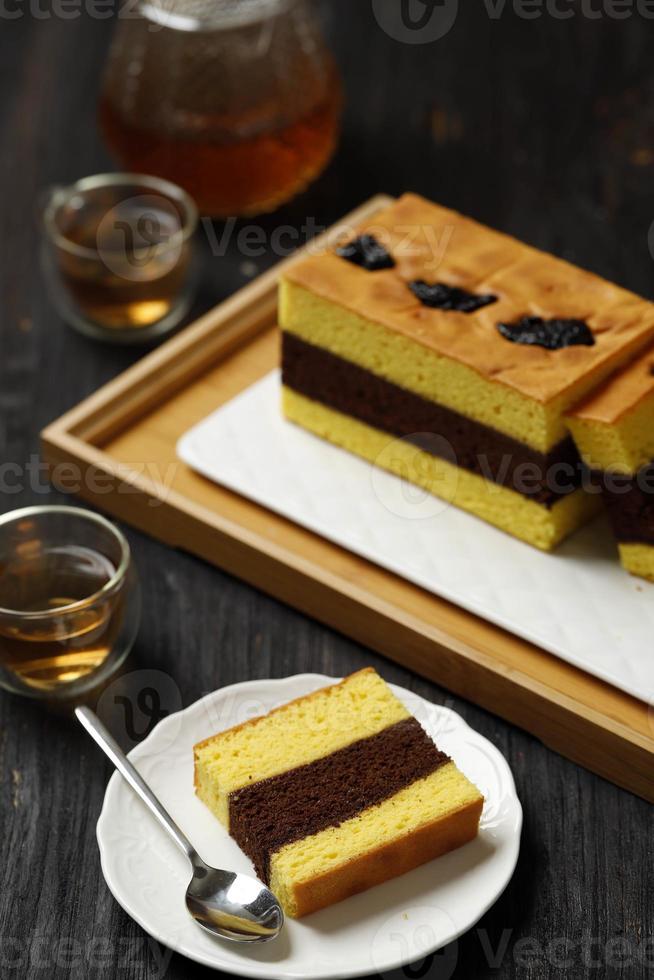 Spiku or Lapis Surabaya, Indonesian  Three Layer Cake with with Strawberry Jam Between the Layer. Topped with Prunes photo