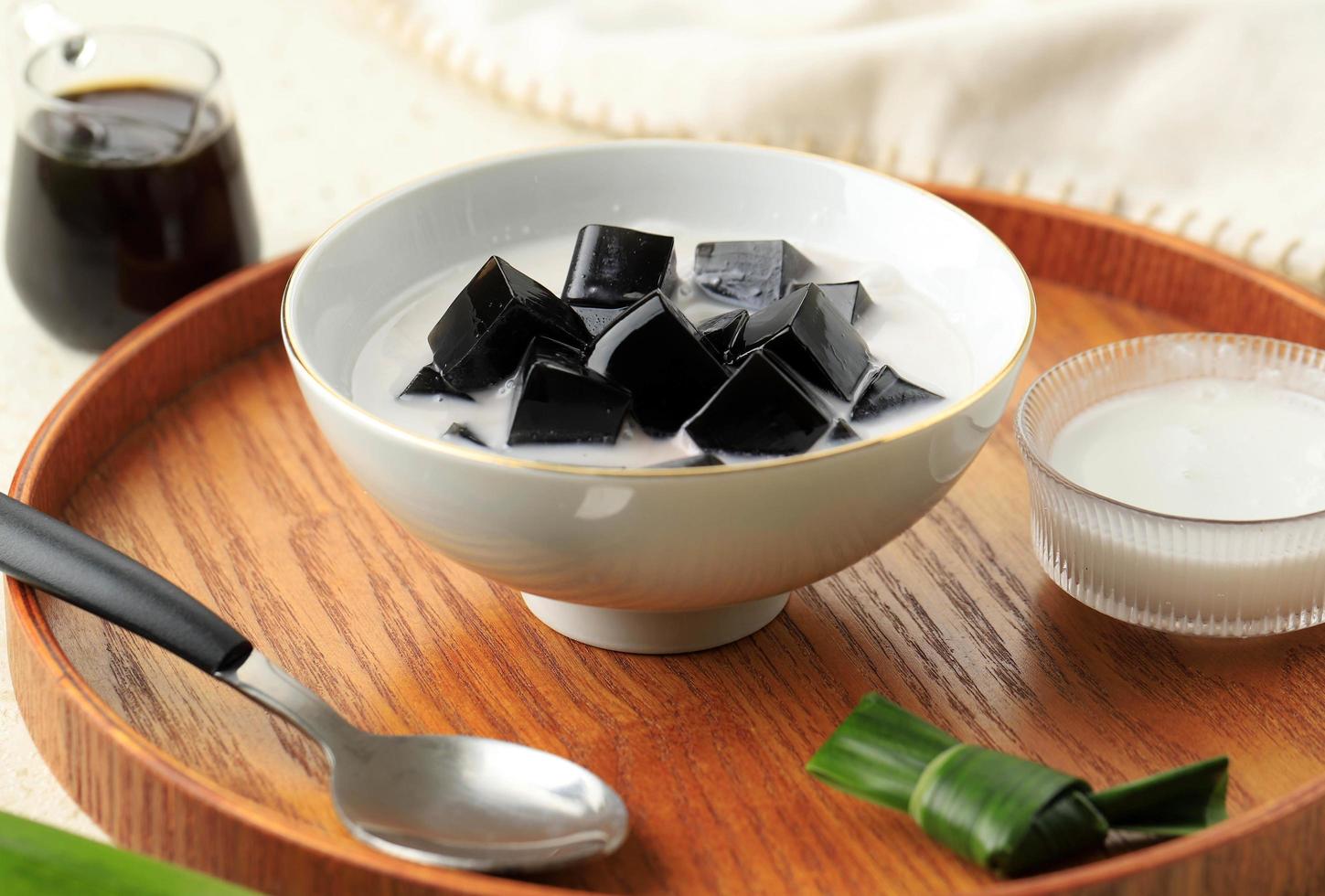 Es Cincau Hitam or Black Grass Jelly Cincau Hitam, Indonesian Dessert Made from Cincau Leaf with Coconut Milk and Palm Sugar. photo