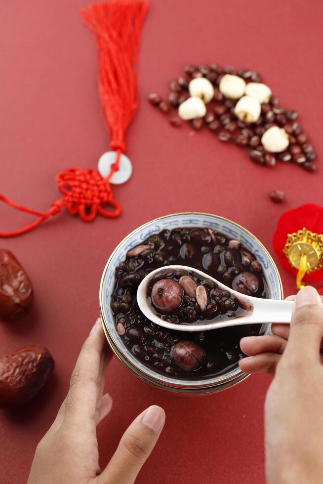 Making Laba Porridge, Chinese Traditional Congee Served at Laba Festival. Top View on Red Theme photo