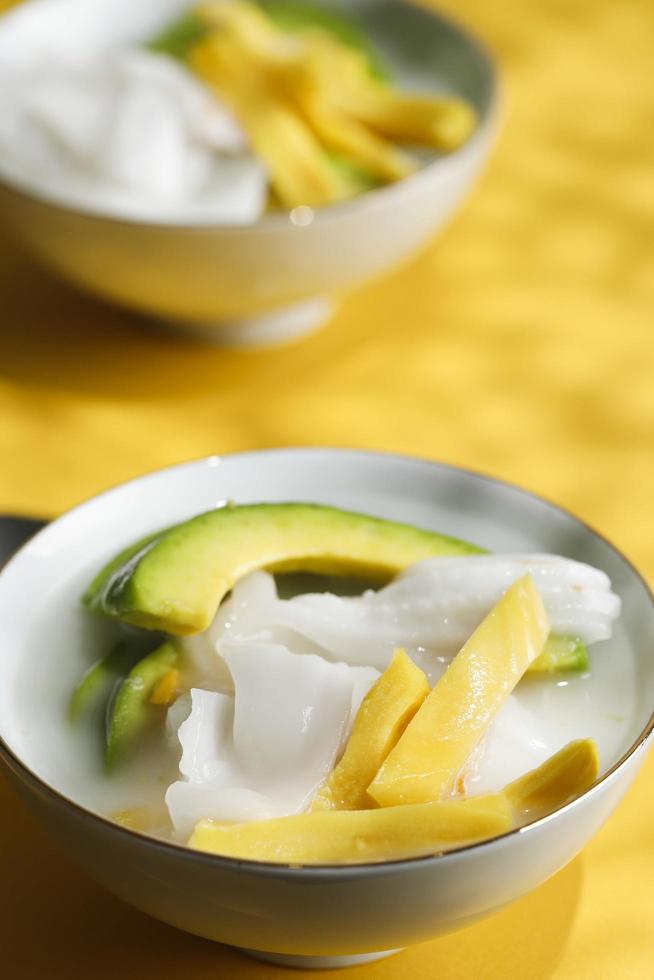 Es Teler, Traditional Indonesian Ice Dessert of Tropical Fruit Cocktail in Sweet Coconut Water and Condensed Milk photo
