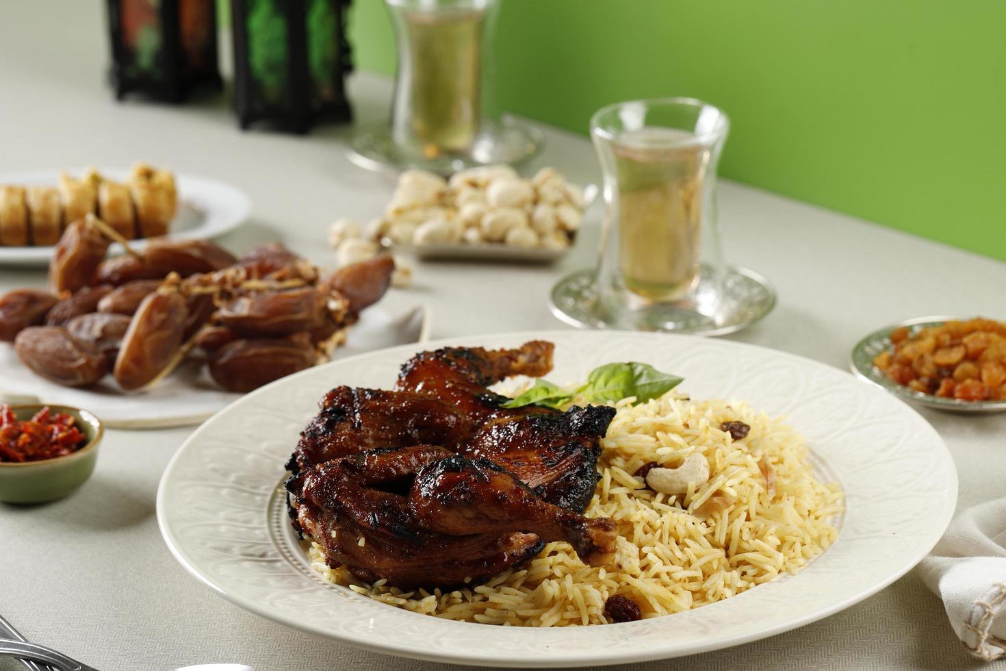 Kabsa, Arabian Dish made of Long Grain Basmati Rice, Roasted Whole Chicken, Onion, Spices Cardamom, Saffron, Cinnamon, Bay leaves photo