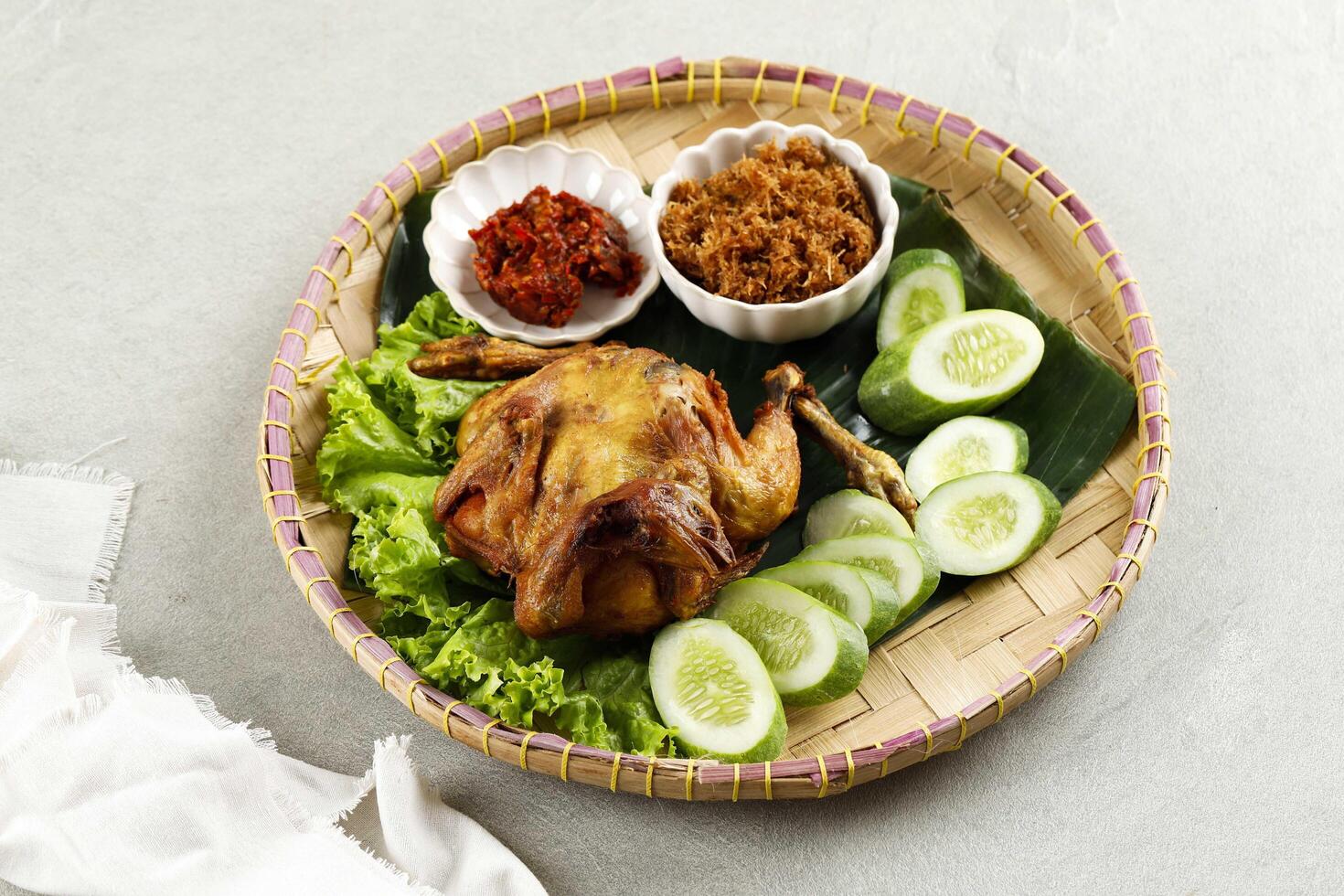 ayam ingkung goreng o bakakak hayam, pollo entero frito, receta tradicional indonesia foto