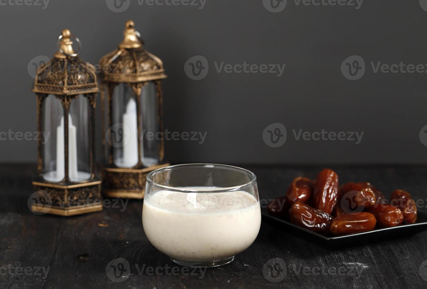 Ramadan Concept. Dates Milk Susu Kurma with Date Fruit in the Background. Ramadan Lantern on Wooden Table. photo