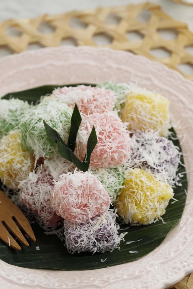 Colorful Ongol-Ongol or Sentiling, Steamed Cassava Cake Coating with Grated Coconut photo