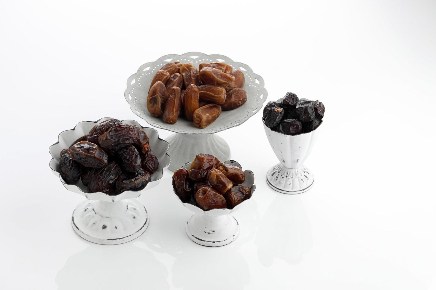 Various type of dried dates fruits on white photo