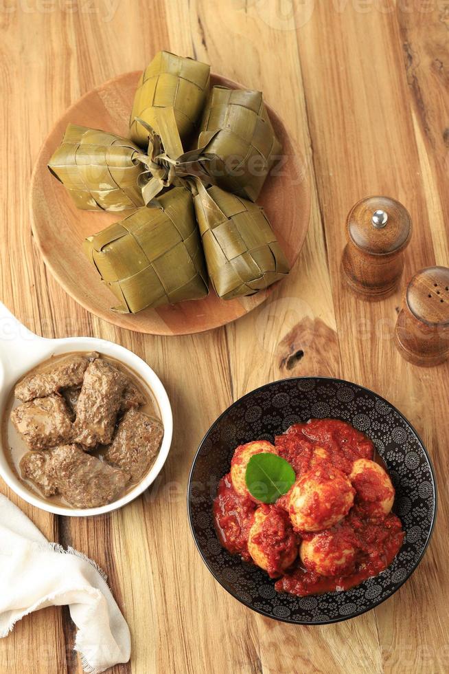 Ketupat, Rendang, and Telur Balado, TOp View on Wooden Table photo