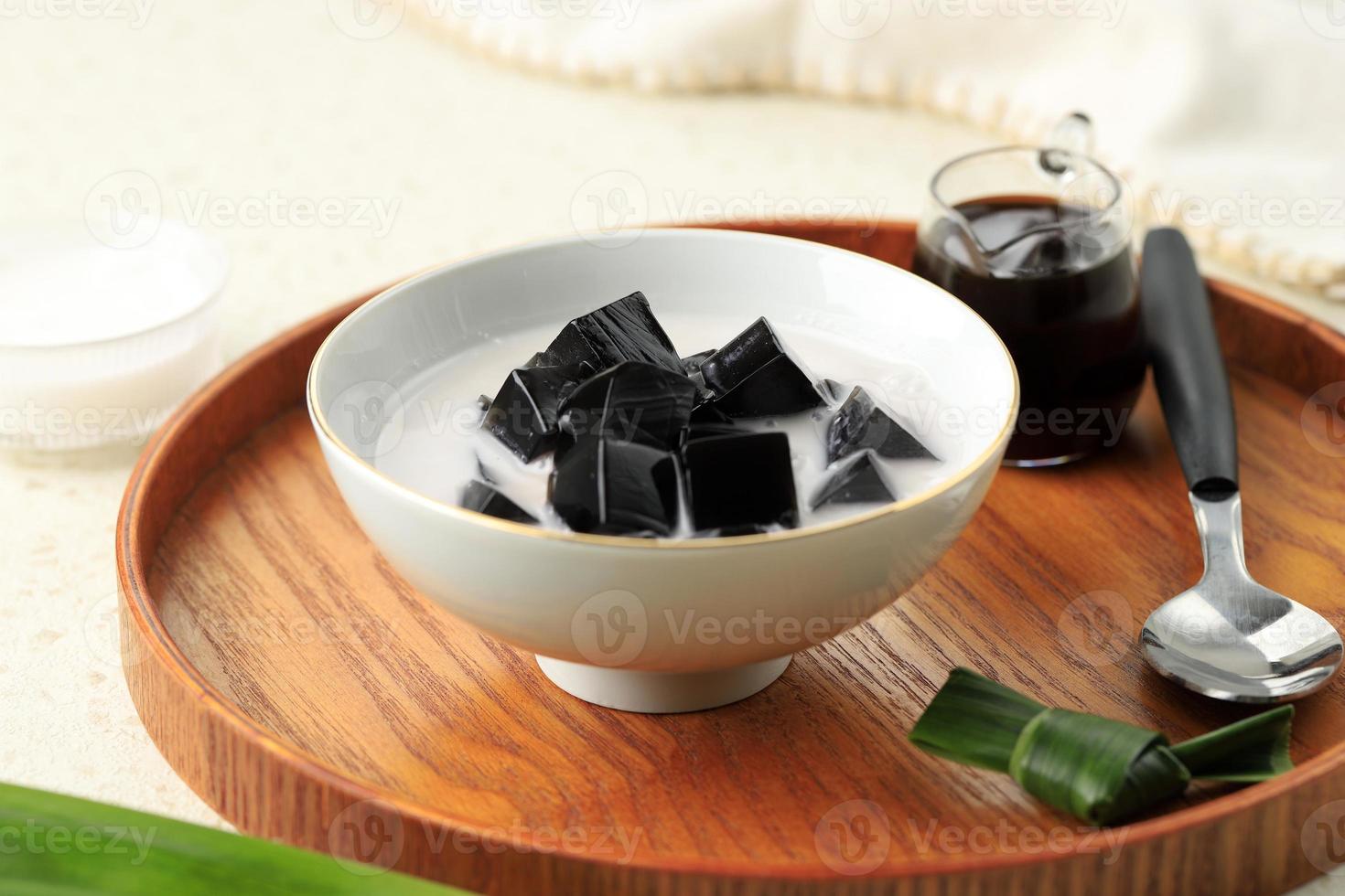 Es Cincau Hitam or Black Grass Jelly Cincau Hitam, Indonesian Dessert Made from Cincau Leaf with Coconut Milk and Palm Sugar. photo