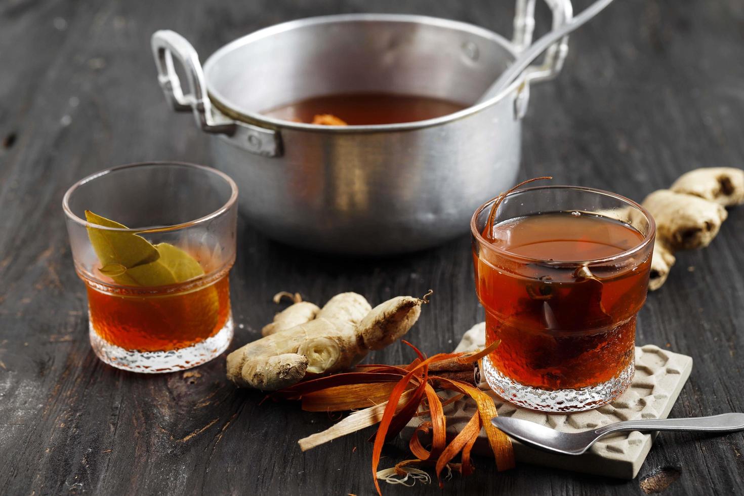 Indonesian traditional drink - wedang uwuh. made of ginger, secang, cloves, cardamom, dried cinnamon. photo