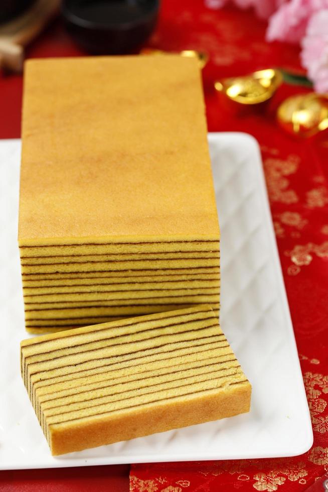 Lapis Legit or Thousand Layers Cake on White Plate. Chinese new year Red Concept photo