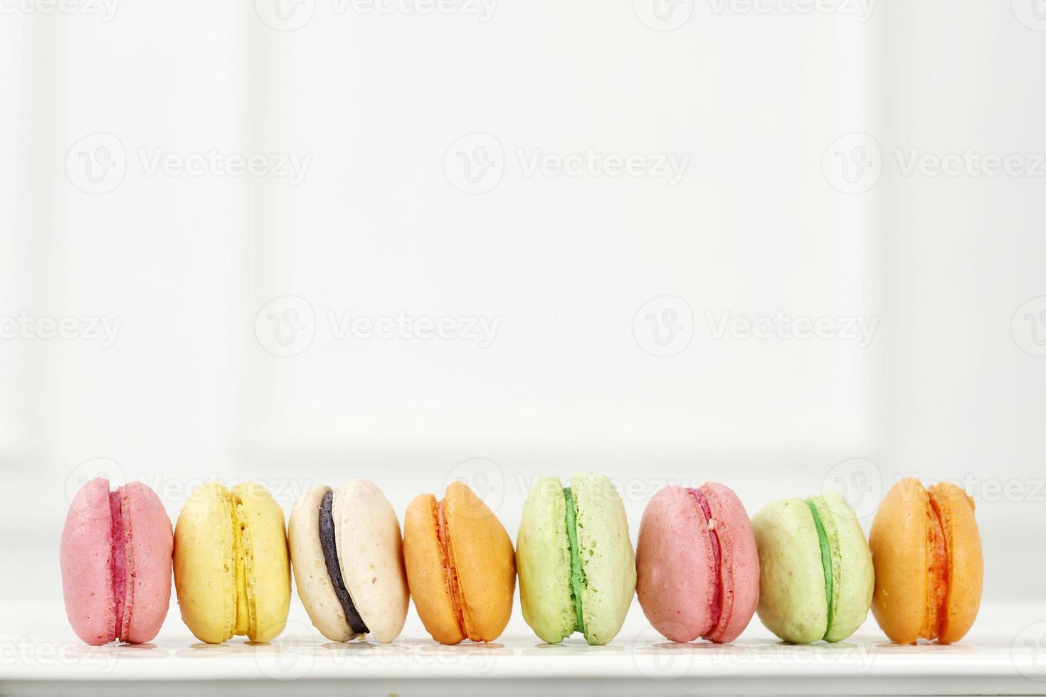Creative layout made of colorful macaroons on the white background. photo