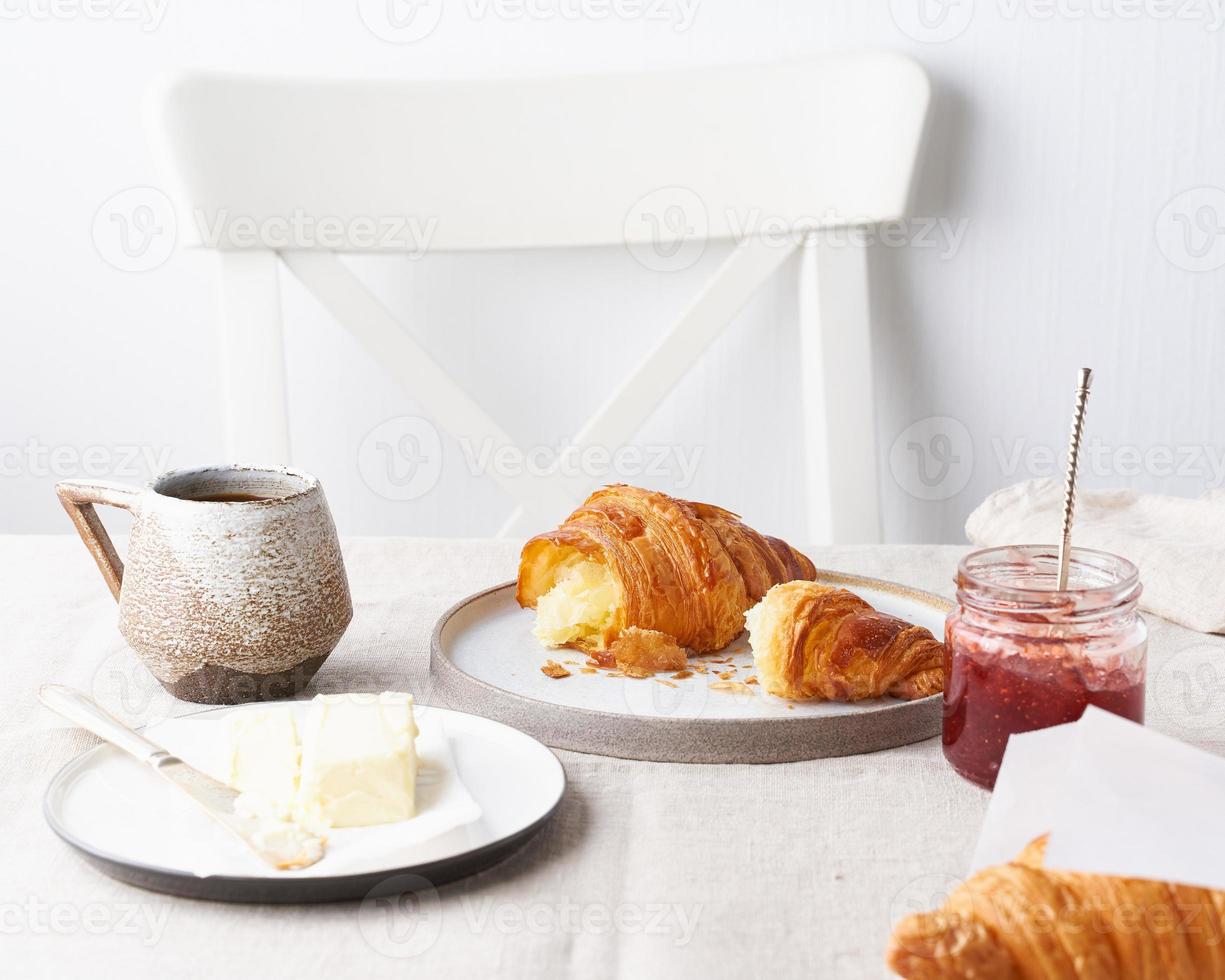 Coffee with a croissant. Sunny morning, breakfast with fresh pastries. Traditional french breakfast photo