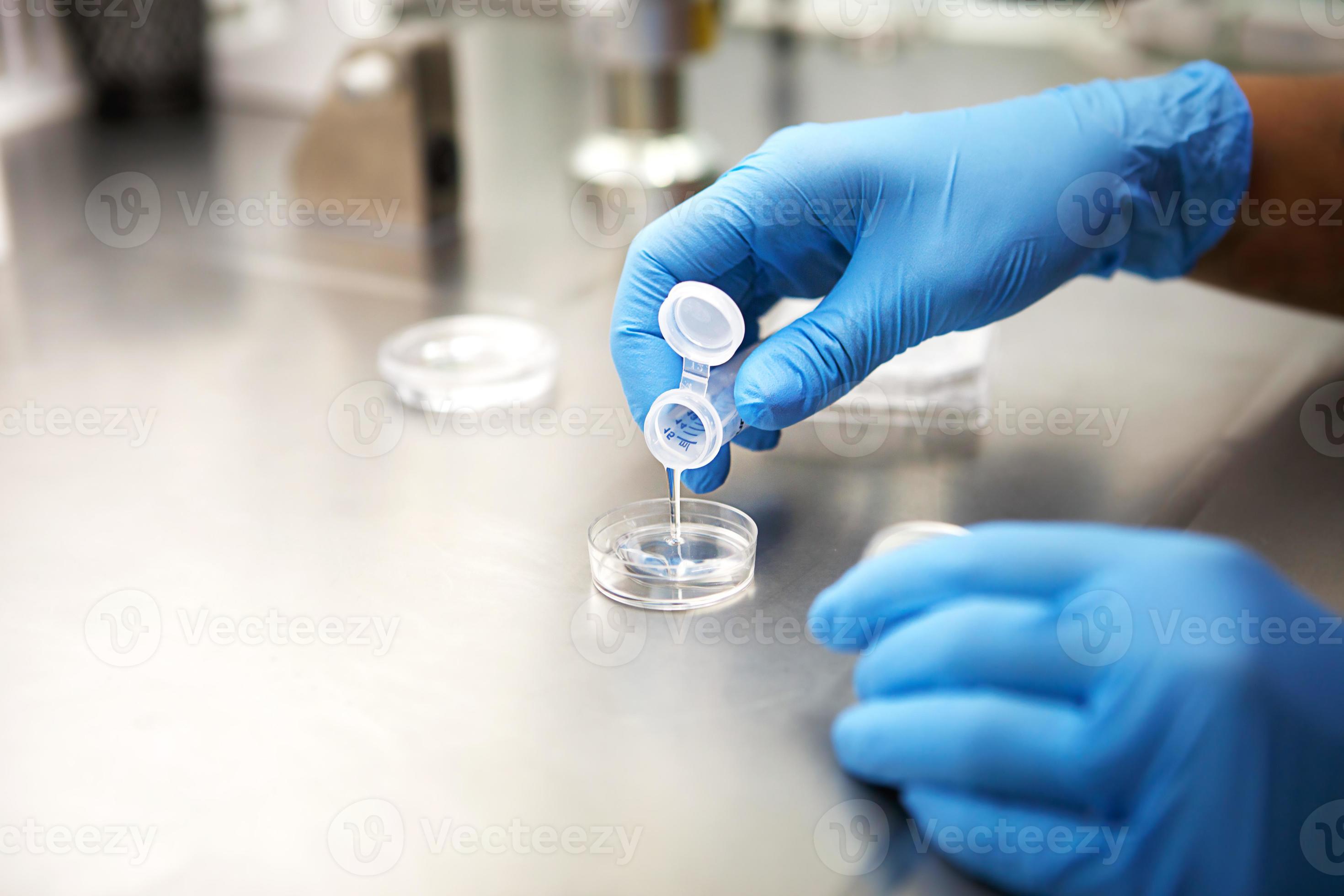 Hands of a scientist in the laboratory with a test tube and a