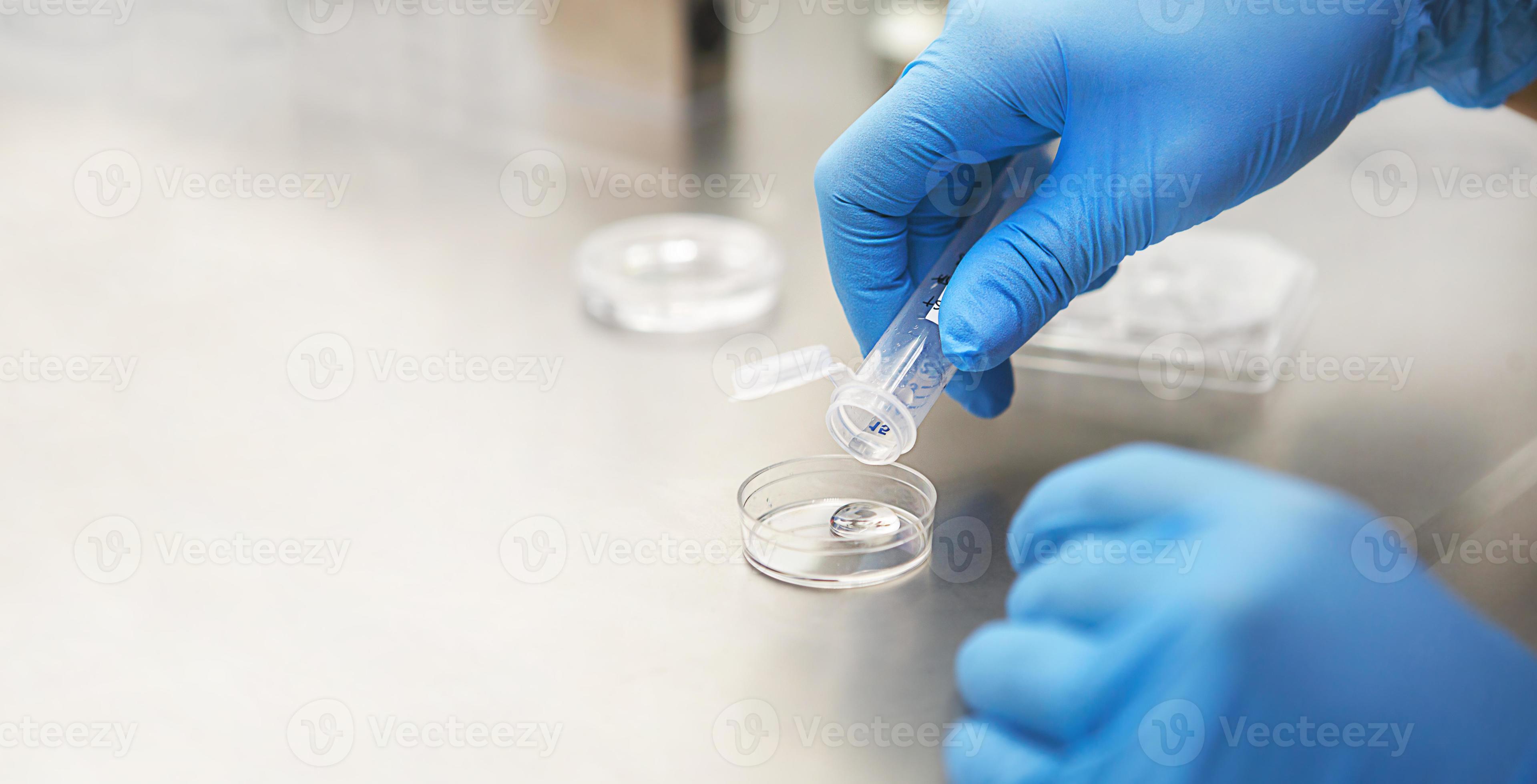 Hands of a scientist in the laboratory with a test tube and a microscope. The invention of the