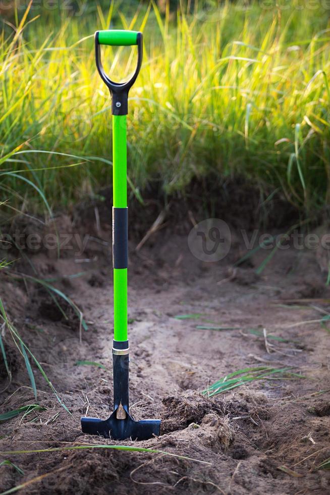 Shovel is inserted into the ground for planting in the spring. Springtime, garden plants, working on a plot of land, landscaping, gardening, growing flowers, fruit crops in the garden. Copy space photo