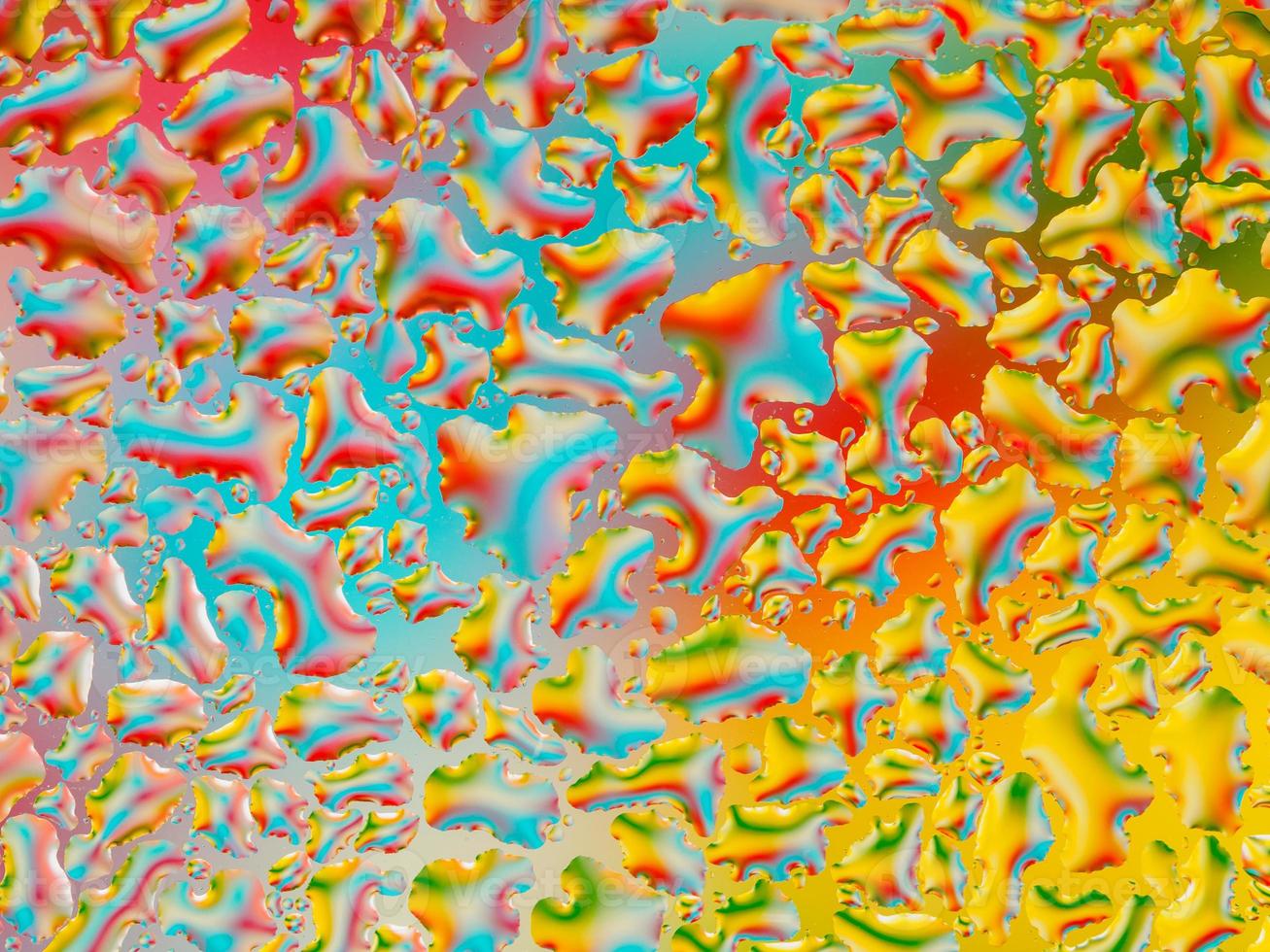 Abstract coloful vivid background with large and small convex drops of water on glass, condensation on window. Macro, close up. photo