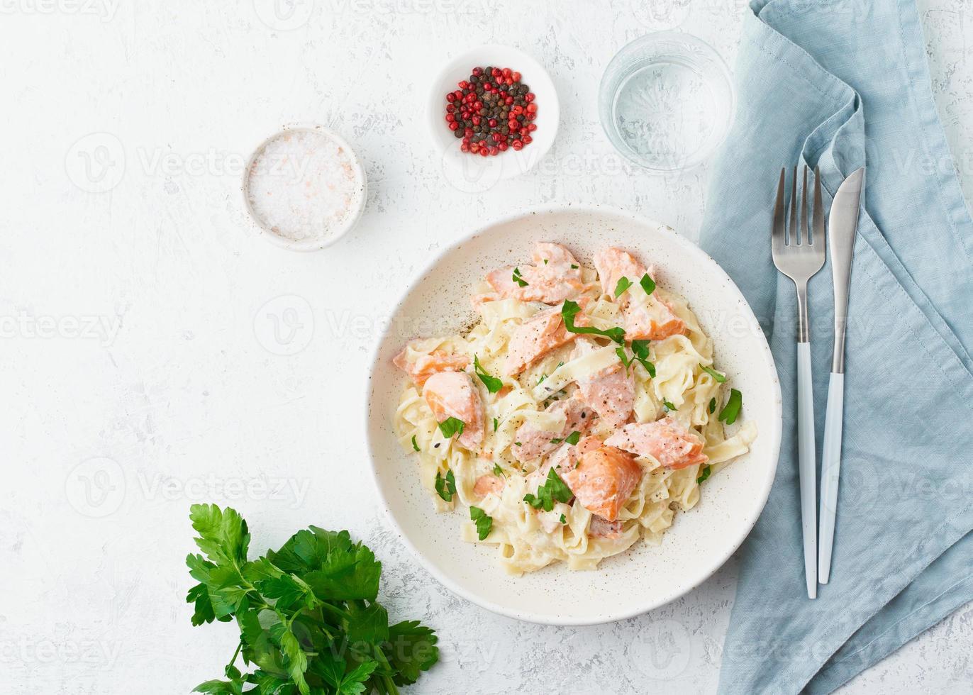 Salmon pasta, tagliatelle with fish and creamy sauce. Italian dinner with seafood photo