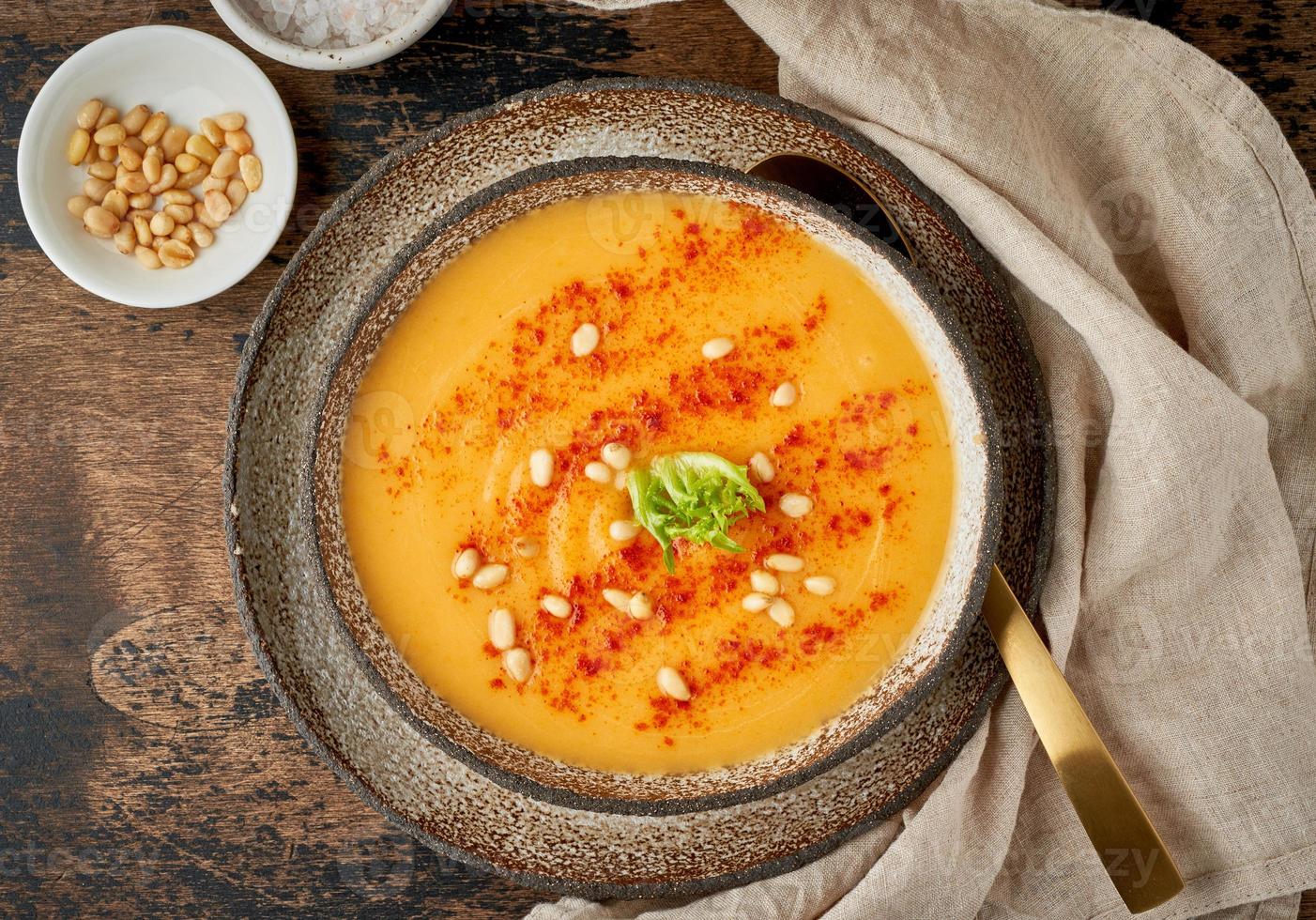 Autumn pumpkin soup with smoked paprika, pine nuts, vegetarian dish photo